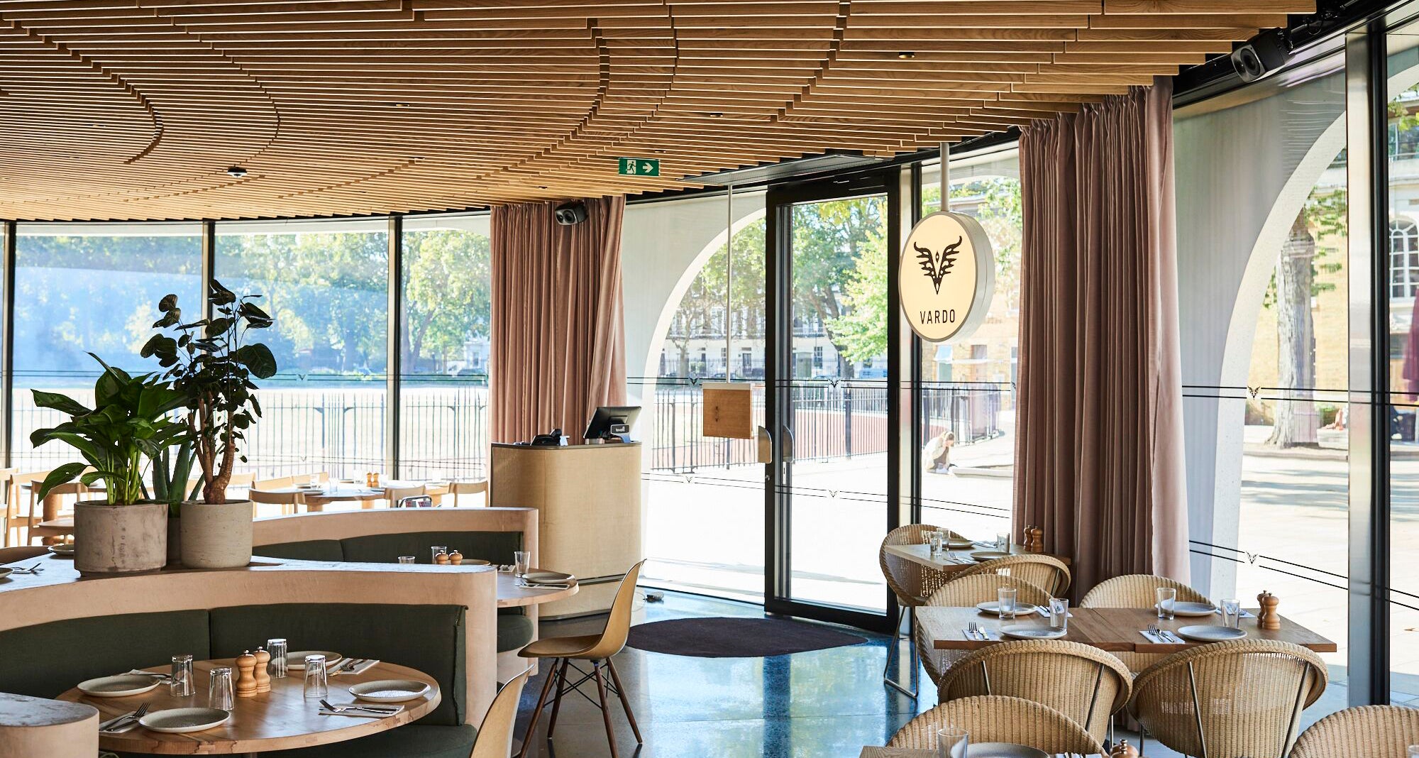 Duke of York Square entrance to Vardo Chelsea restaurant with large sunny windows and dining room tables