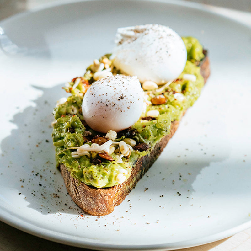 Caravan restaurants smashed avocado with poached eggs on The Snapery East sourdough toast