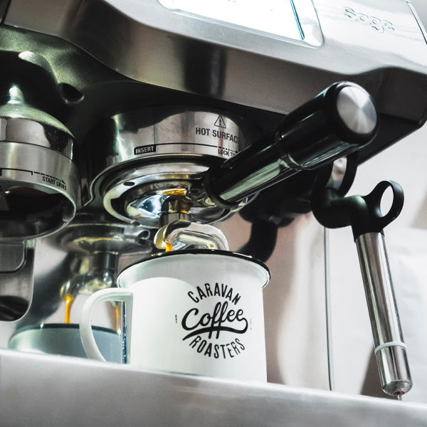 Caravan Coffee Roasters enamel mug and espresso machine
